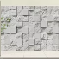 White Textured Stone Wall with Square Blocks and Green Plant in Interior Design