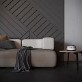 Beige Two Seater Sofa With Brown Grey Pillows Throw Blanket Side Table And Geometric Wall