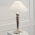 Modern Table Lamp With White Lampshade And Metal Base On White Wall Background
