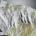 Mountainous Rocky Terrain Featuring Steep Cliffs Green Vegetation And Natural Texture