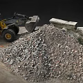 Yellow Loader At Construction Site With Rubble Pile And Large Stones