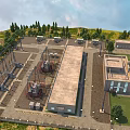 Large Industrial Factory Building Complex with Surrounding Trees Roads and Equipment