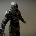 Man In Black Combat Armor With Red Glowing Eyes And Mechanical Helmet Details