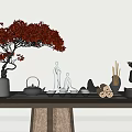 Ornament Decor Combination With Red Flowering Tree Green Figurines Black Teapot And Wooden Table