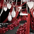 Wedding Floral Display With Red Curtains Crystal Chandeliers And Pink Red Flowers On Black Stage