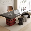 Modern Dark Top Desk with Red Stacked Base Laptop Headphones Green Plant and Brown Chair