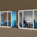 Comfortable Public Chairs in Glass Cubicles with Blue Sofas and Chatting People