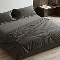 Double Bed with Gray Bedding Wooden Nightstand Wicker Chair White Walls Wooden Floor Stone Shelf