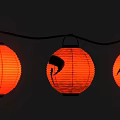 Decorative Orange Festive Lanterns Strung Together with Black Design on Middle One 3d model