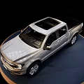 Shiny Silver Four Door Pickup Truck On Circular Display Platform With Black Background