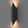 Modern Black Geometric Wall Lamp with Warm Light Glow on Gray Wall