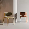 Two Stylish Leisure Chairs in Green and Orange with Minimalist Interior Background