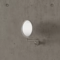 Wall Mounted Oval Swivel Mirror With Metal Bracket On Concrete Wall