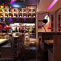 Modern Restaurant Interior With Red Pendant Lights Wooden Tables And Cat Wall Decor