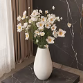 White Vase with White Daisies on Black Marble Tabletop against Dark Marble Wall and Curtain