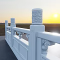 White Decorative Fence with Carved Pillars and Sunset View Over Field And Gray Pavement