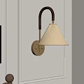 Elegant Wall Lamp With Gold Base Cream Shade And Black Curved Arm On White Wall