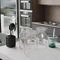 Modern Kitchen Countertop With Black Utensil Holder Glass Jars And Green Liquid Cup