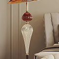 Elegant Modern Floor Lamp With Red Top And Transparent Glass Base By Sofa