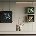 Light Colored Wall Interior With Black Framed Artworks And White Vase With Dried Branches