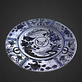 Blue and White Plate Decoration Featuring Floral Patterns and Fish Motif
