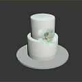 Two Tiered White Cake With White Flower Decoration On Silver Round Tray