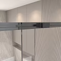 Modern Textured Stainless Steel Door Handle Mounted On Glass Door With Marble Wall Interior
