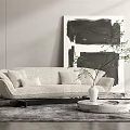 Beige Multi Seater Sofa With Cushions Black And White Abstract Painting And Round Coffee Table