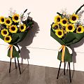 Floral Display With Sunflowers Green Wrapping And Orange White Ribbons On Black Tripods