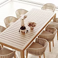 Wooden Outdoor Table With Rattan Chairs And Decorative Vase Fruit Bowl Setting
