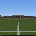 Soccer Field With Players In Action During Match With Spectators In Stands