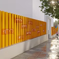 Modern HouBao Building Exterior With Yellow Facade Trees And Waterfront Seating Area