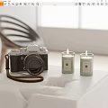 Fujifilm Digital Camera Display With Two Lit Candles On White Table Top