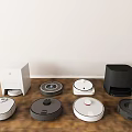 Different Colors And Styles Of Robotic Vacuum Cleaners As Daily Household Appliances On Wooden Floor