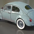 Light Blue Vintage Beetle Car With Curved Body And White Wall Tires