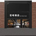 Exterior View Of The Coffee Hotel With Red Brick Wall Black Signage And Glass Doors