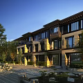 Modern Detached Villa Exterior Design With Large Windows Glass Balcony Evening Lighting And Greenery