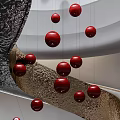 Black Spiral Staircase With Hanging Red Spheres In Modern Interior Design