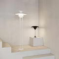Modern Lighting Combination with White Floor Lamp and Black Table Lamp on White Pedestals