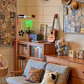 Cozy Light Gray Leisure Chair In Room With Wooden Furniture Green Plants And Guitar