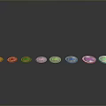 Carved Coin Sculptures In Different Colors Arranged In A Row With Metallic Finish
