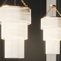 Modern Layered Ribbed Chandeliers Hanging On Gold Chains Against Dark Wall