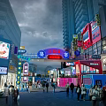 Bustling Commercial Street With Tall Buildings Bright Neon Signs Crowded Pedestrians Shops And Archway