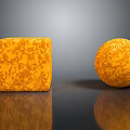Orange Textured Cube And Sphere With Intricate Patterns On Black Surface