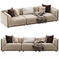 Cozy Modern Beige Three Seater Sofa With Brown White Pillows And Throw Blanket