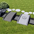Landscape Bridge Design With Stone Structure And Lotus Shaped Stepping Stones In Green Grassy Area