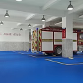 Red Fire Truck Parked On Blue Floor With White Pillars Yellow Seats And White Ceiling