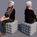 Smiling Woman Sitting On Textured Cube Stool Wearing Headscarf And Black Outfit