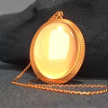 Decorative Jewelry Ornament Set With Gold Oval Shiny Pendant On Black Stone Background
