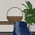 Woven Rattan Basket On Wooden Table With Green Plant And Blue Cloth